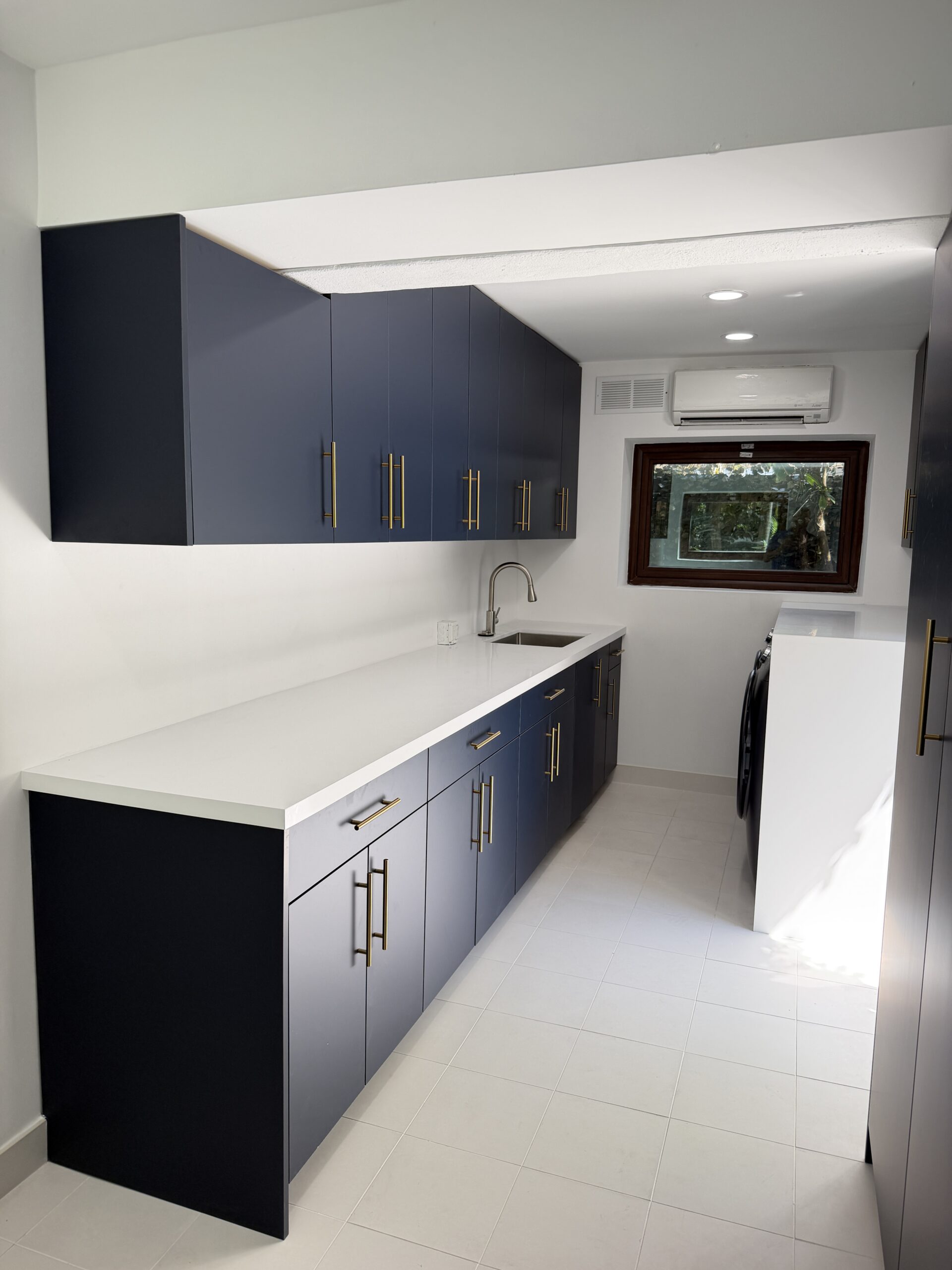 Laundry and mudroom with built-in desk nook and quartz counters